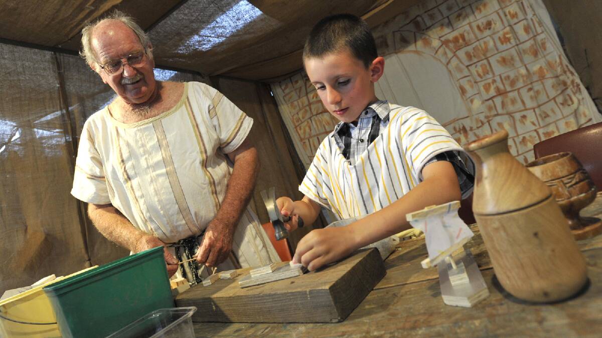 Darcy McGregor gives Ananasius Casanova, 9, some pointers in the carpenters workshop at Bethlehem. Picture: Les Smith