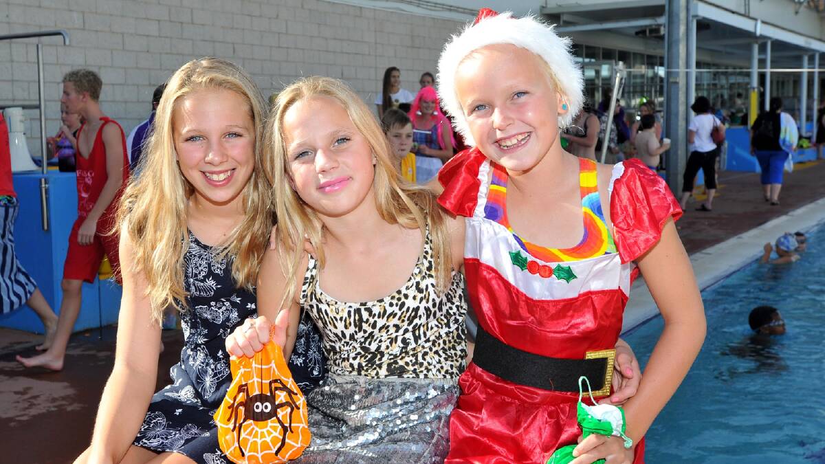 Molly Devries, 12, Millie Himmelberg, 13, and Meg Senior, 10, at the Wagga Swimming Club Christmas Party at the Oasis. Picture: Michael Frogley