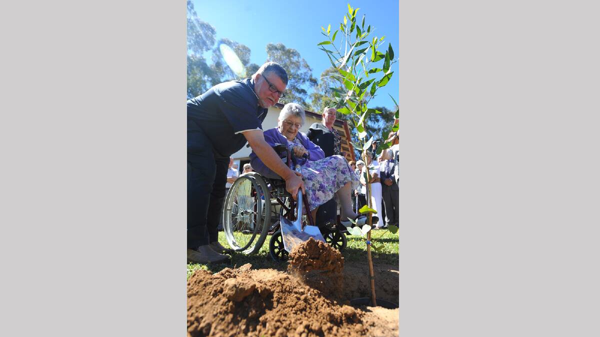 Betty Oehm (centre) was The Rock Uniting Church's organist for 60 years, plants a tree out the front as part of the centenary celebrations with David Oehm and Virginia Auld. Picture: Addison Hamilton