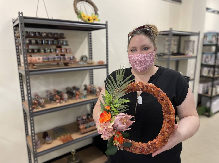 TIME TO SHINE: Brand new business owner Ashley hills shows off one of the crystal resin wreathes she is selling from her space in the Riverina Local Pop Up. Picture: Penny Burfitt