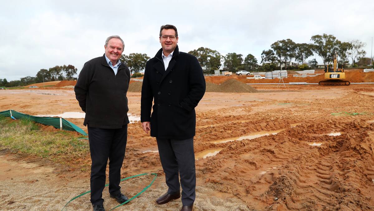 MAKING PROGRESS: Property manager with the Catholic Diocese of Wagga Peter Fitzpatrick and Fitzpatrick's Real Estate's Geoff Seymour on the site of the recently-approved Boorooma shops. Picture: Emma Hillier 