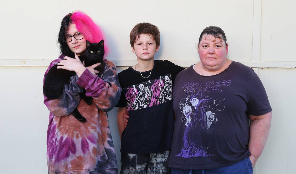 NO PLACE LIKE HOME: Milli Paull, 14, with Fundly the cat, Blake Paul, 11, and mum Kathleen Heritage at their new home. Picture: Emma Hillier