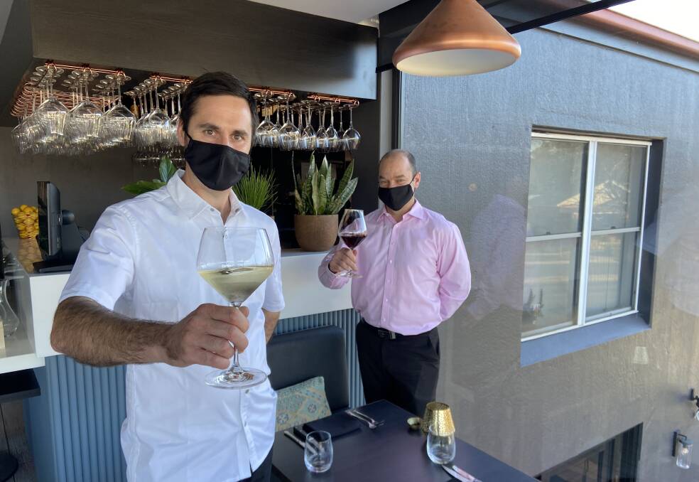 ROUNDABOUT REBORN: The newly named The Charles Boutique Hotel and Dining's executive chef David Obudzinski and General Manager Jamie Pascoe toast their reoponing. Picture: Penny Burfitt
