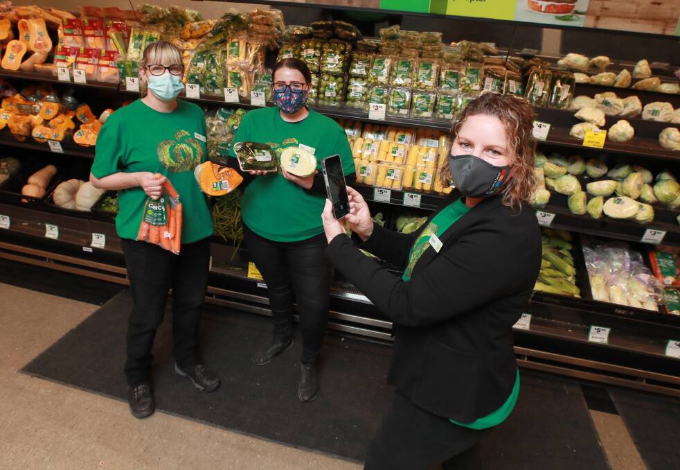 VIRAL VIDEO: Colette Goldspink (right) shot a TikTok video with team members including (left) Lucinda McGill and Sami Jo Fischer at Woolworths Wagga. Picture: Les Smith