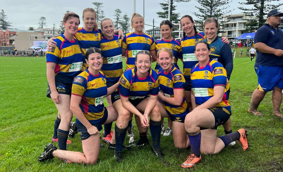 HISTORIC: The Albury-Wodonga Steamers women are all smiles after claiming their first trophy at the Kiama sevens tournament in wet and wild conditions on the weekend.
