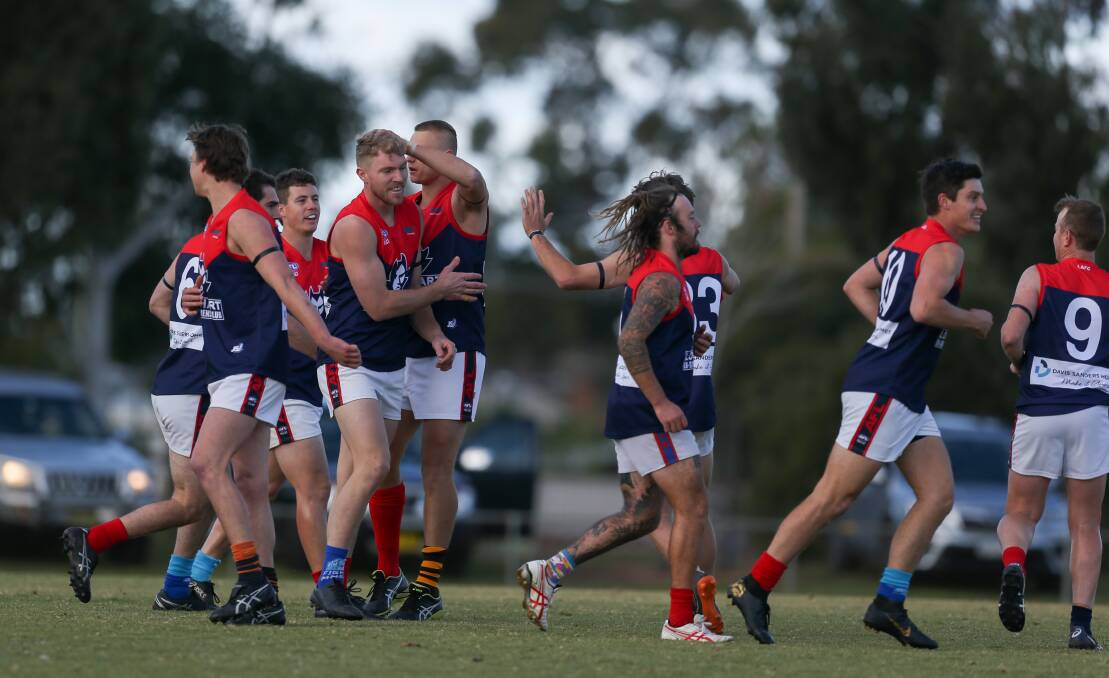 LOCK IT IN: Andrew Emery is congratulated after kicking one of his three goals in Lockhart's narrow win away to Howlong. Picture: TARA TREWHELLA