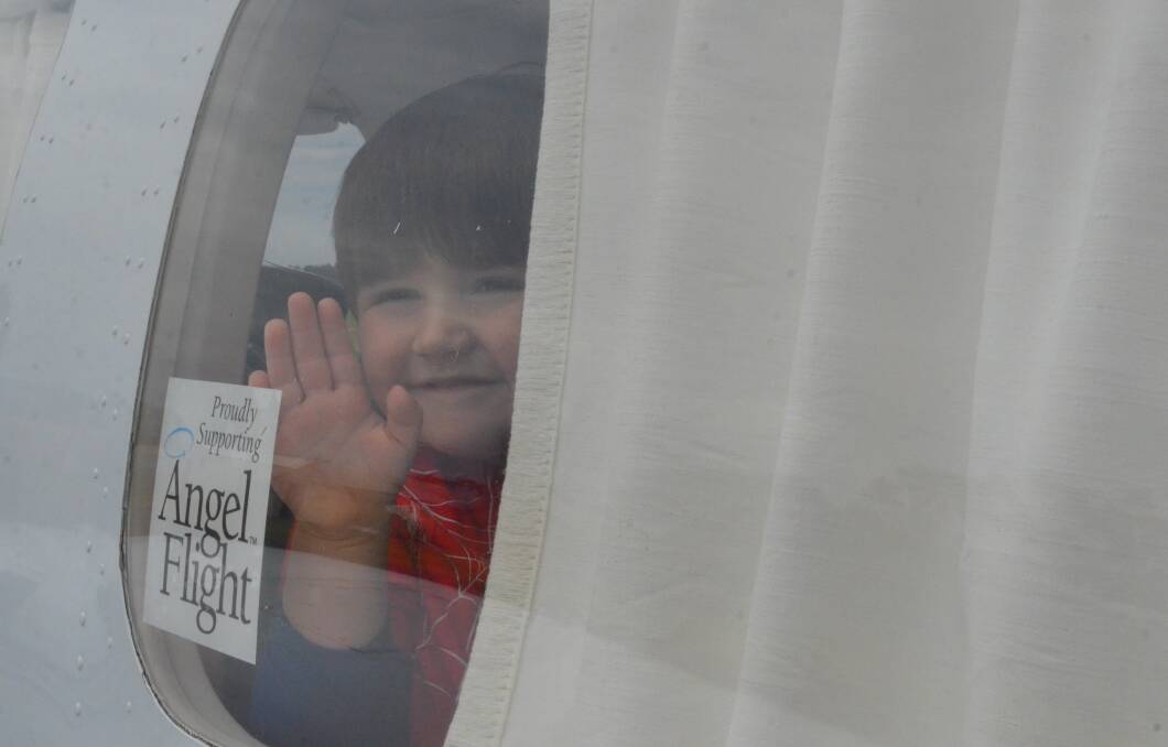 GOING HOME: Memphis Francis, 3, waves goodbye to his grandparents Mark and Alex Facer onboard his Angel Flight to Queensland on Friday morning. PHOTO: Cai Holroyd