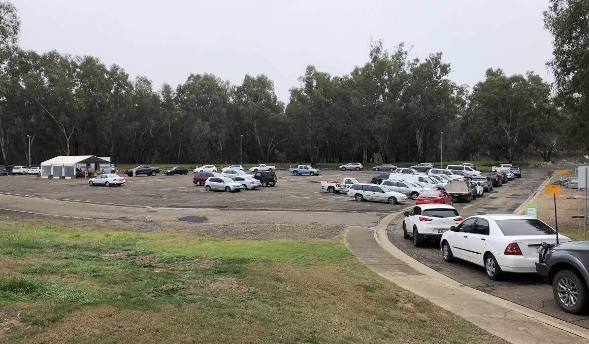 Cars lined up all morning to be tested at the drive-through clinic at Wagga Beach. Picture: Emily Wind