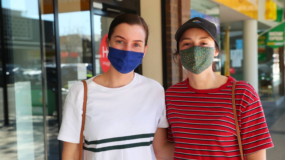 Jess Mielke and Amy Tier donning their masks in September on the first day out of lockdown. Picture: Emma Hillier