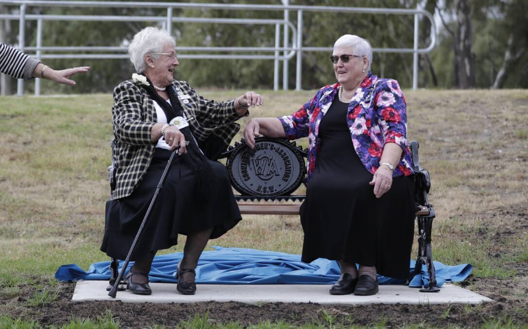 MILESTONE: Past state president and vice-president of the NSW Country Women's Association, Elaine Armstrong and Ann Adams, were the first to take a seat on a commemorative park bench. Picture: Madeline Begley