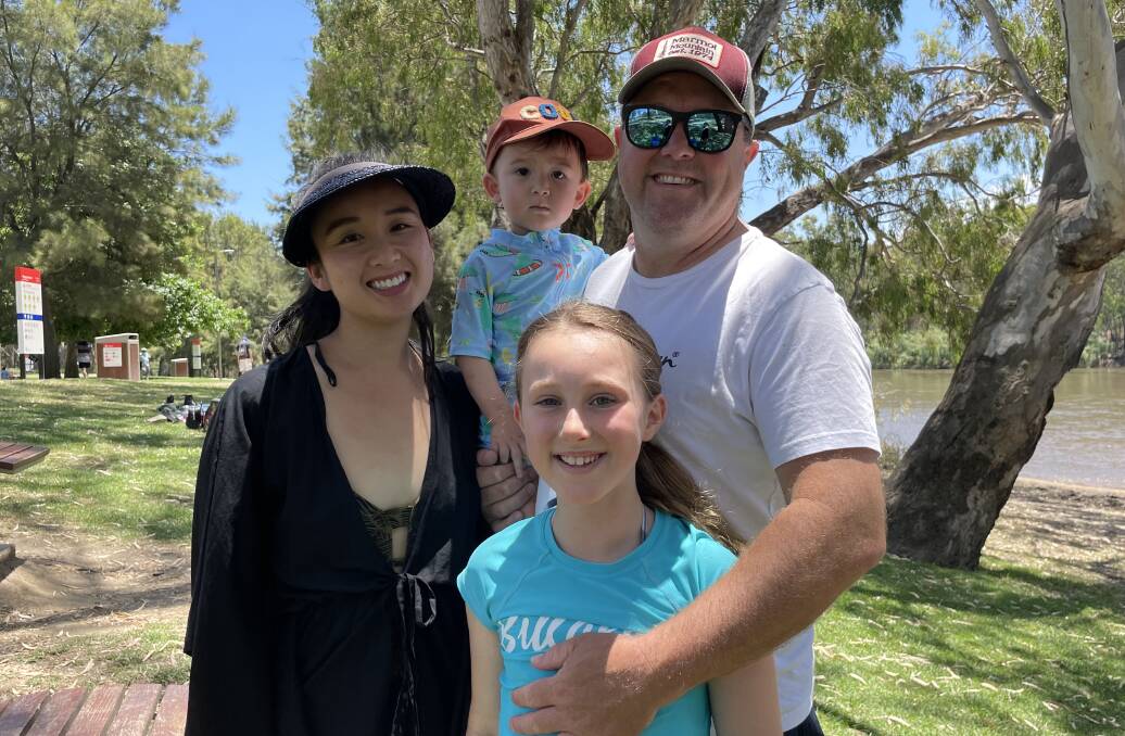 Noreen Vu and Howard Povey with children Alanna and Henry Povey, who all spent time swimming at Wagga Beach on Boxing Day. Picture: Emily Wind