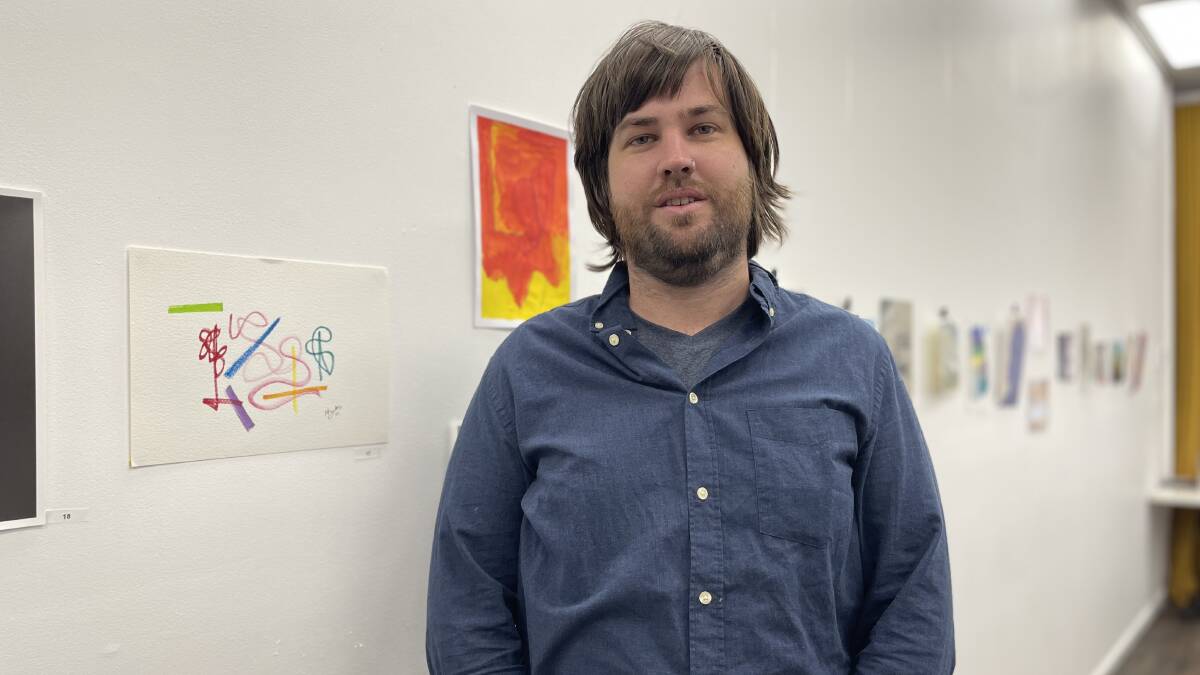 Local artist Myles Pragnell with his artwork, set to be auctioned off on Sunday. Picture: Emily Wind