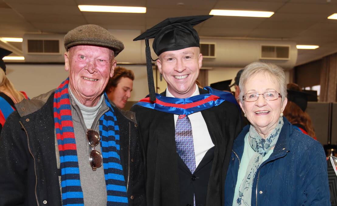 PROUD FAMILY: Patrick Murray, who completed his Master of HR Management, poses with his parents Kevin and Pam Murray from Sutherland at the CSU graduation ceremony on Thursday morning. Picture: Les Smith