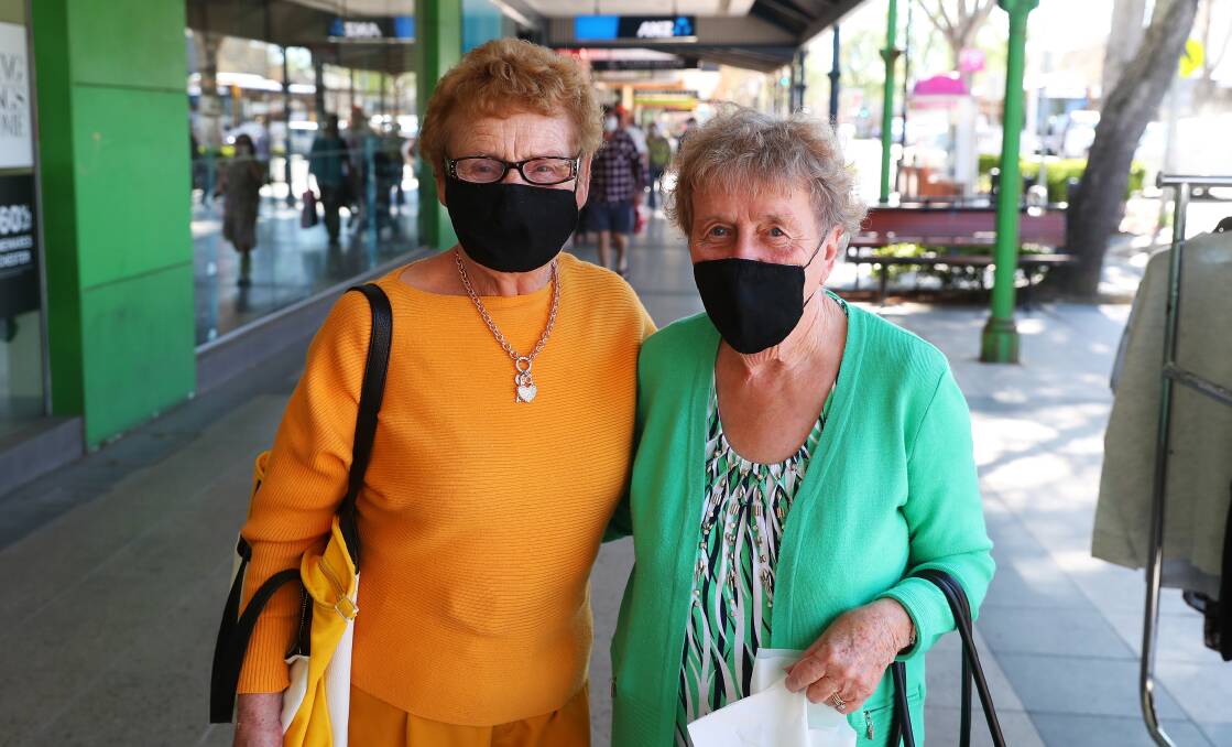Patricia Bowditch and Gwen Little from Wagga wearing their face masks while shopping on the weekend. Picture: Emma Hillier
