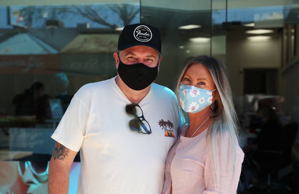 Glenn and Karen Pallister were masked-up on Saturday morning while lining up for a store on Baylis Street in Wagga. Picture: Emma Hillier