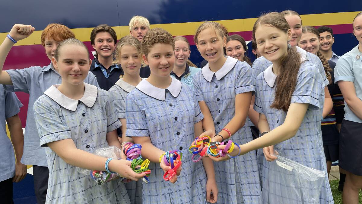 COLOURFUL: Year 7 and 8 students at Mater Dei high school were excited to collect their new wristbands on Tuesday morning. Picture: Emily Wind