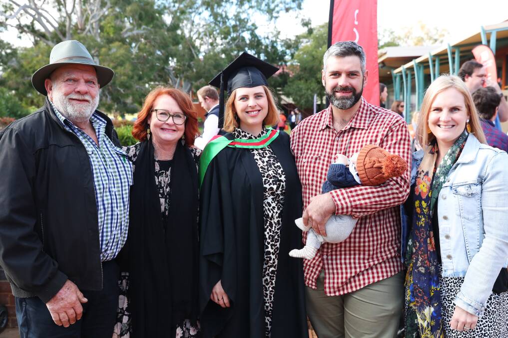 HUGE DAY: Steve McKay, Chris McKay, Stewart McGinty, Archie McGinty, 11 weeks, and Liz Harrison watched on proudly as Kate McGinty (centre) graduated from Charles Sturt University on Friday, closing off the final chapter of her university journey. Picture: Emma Hillier