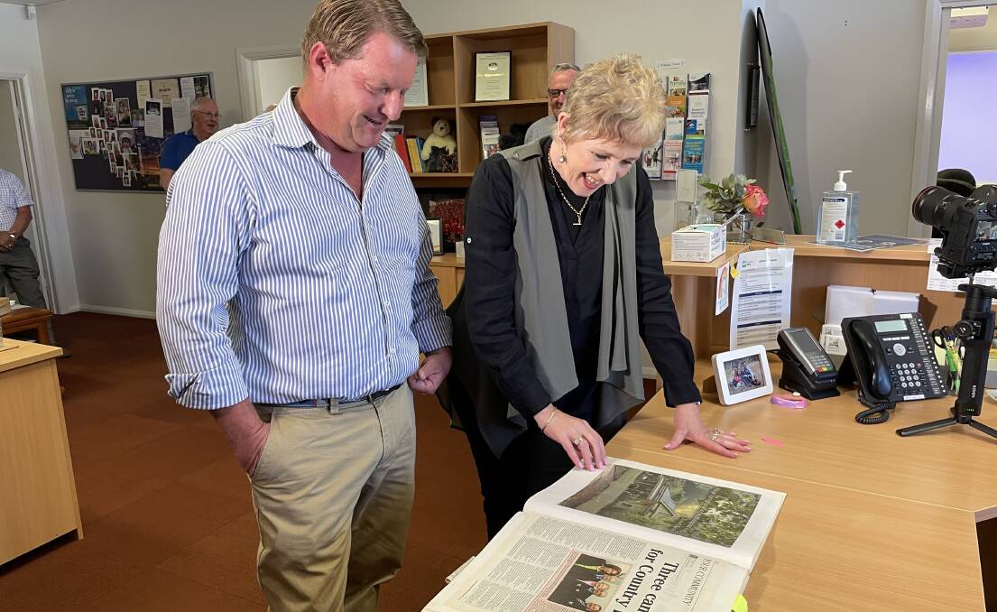 Wagga businessman Richard Allsopp and Country Hope general manager Ellie Webb looking through memories of the business from the past 16 years. Picture: Emily Wind