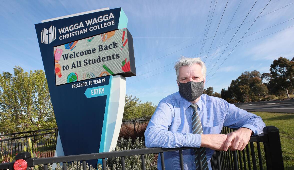 Christian College principal Phillip Wilson welcoming students back to school last month when lockdown was lifted. Picture: Les Smith