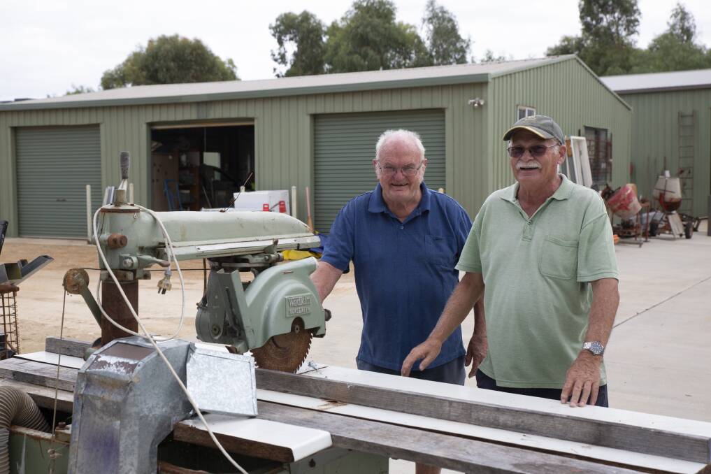 Wagga Men's Shed past president Rick Priest with current co-vice president John Killalea and a docking saw that will be up for auction on Saturday. Picture: Madeline Begley 