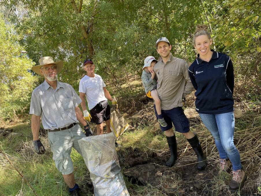 WORKING HARD: John Smith, Al McMillan, Ed and Kaden Maher and Alice Kent clearing Flowerdale Lagoon today. Picture: Emily Wind