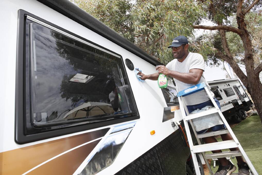 GETTING READY: Tim Waqaisavou with Parkes Viscount and Franklin Caravans polishes the exterior of a caravan ahead of this weekend's lifestyle and leisure roadshow. Picture: Les Smith