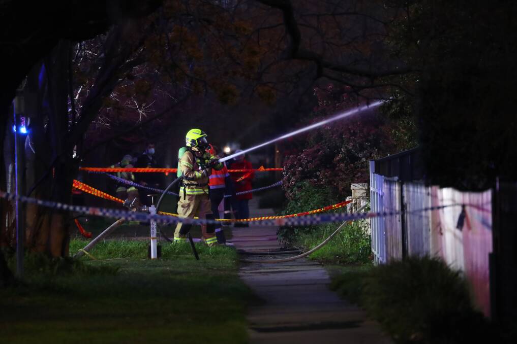Firefighters extinguishing a house fire on Docker Street in Wagga on Saturday evening. Picture: Emma Hillier