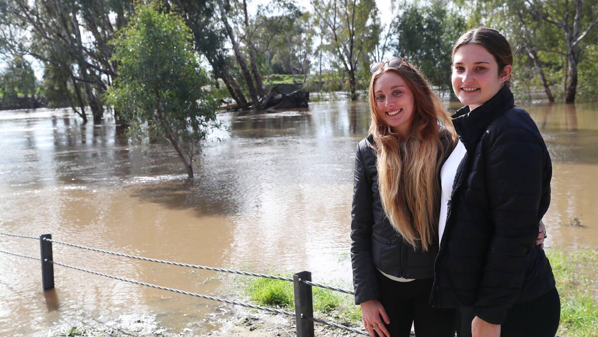 ON THE UP: Murrumbidgee water levels are rising across Wagga, with Wiradjuri Reserve and boat ramp flooded. Pictured: Kristi De Jong and Ashleigh Lloyd of Wagga. Photo: Emma Hillier 