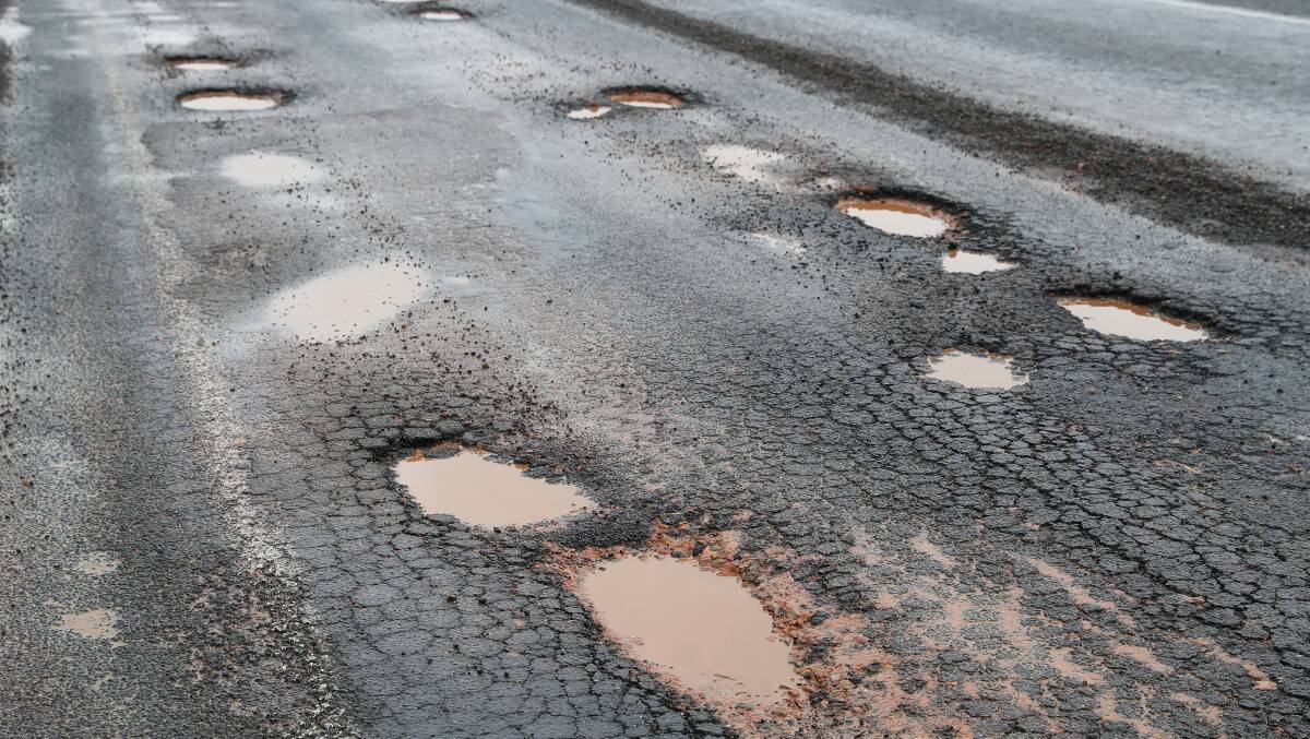 CAUSE FOR CONCERN: The potholes unveiled at Red Hill Road on Monday, make for difficult driving for road users. Photo: Emma Hillier 