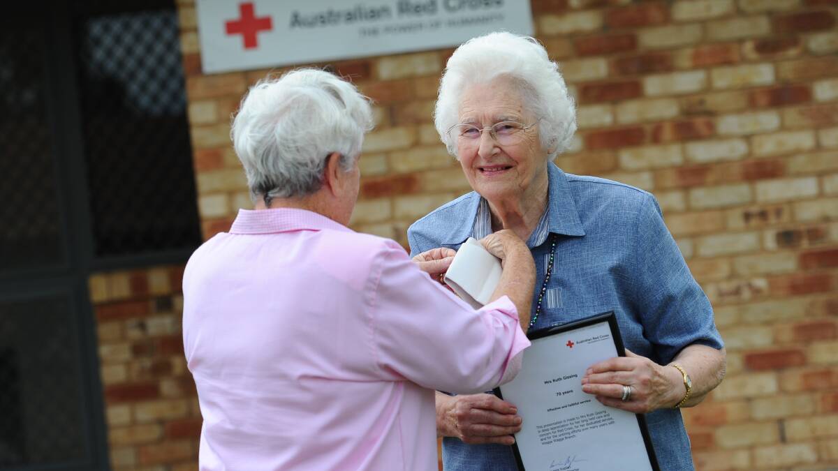 Ruth Gissing receiving an award for 70 years service to the Red Cross..
