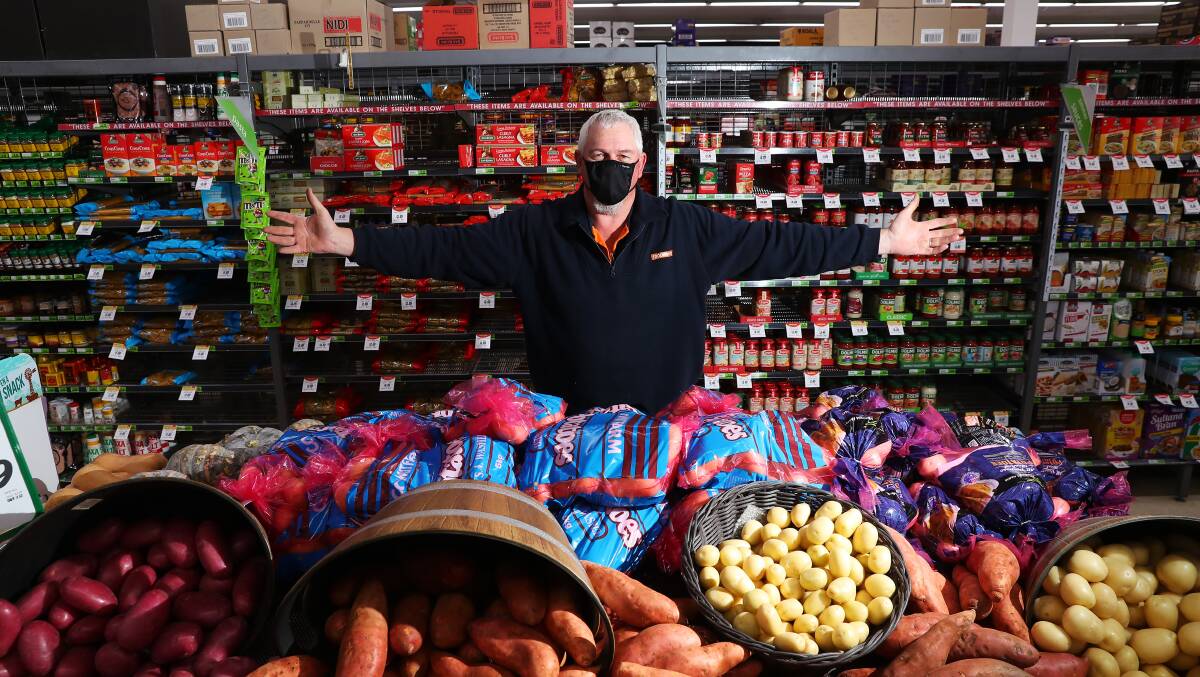 BOUNTY OF GOODS: Lake Albert Foodworks staff member Paul Caller with a plentiful supply of fruit and vegetables. Picture: Emma Hillier