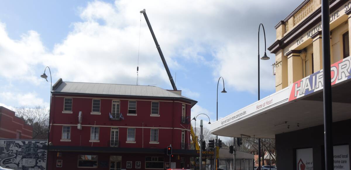 LIFT REMOVAL: A crane dominates the skyline above Romano's hotel yesterday. Picture: Sean Cunningham