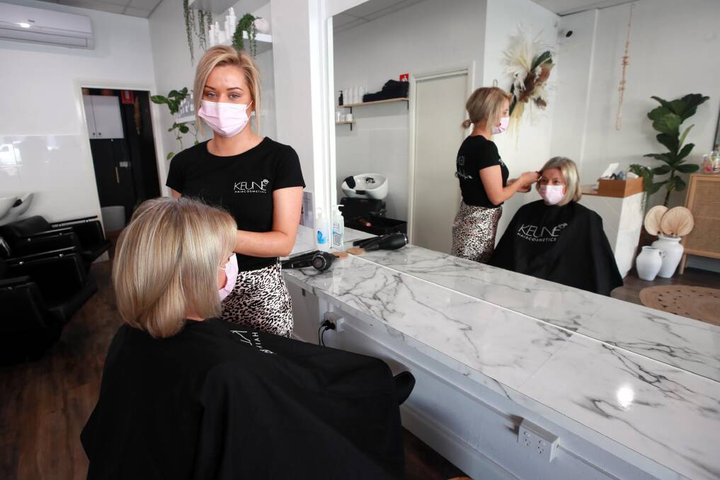BUSY: Katie Coote welcomed customers back to The Style Bar on the first day out of lockdown on Saturday. Tracey Bell received a long awaited trim. Picture: Les Smith