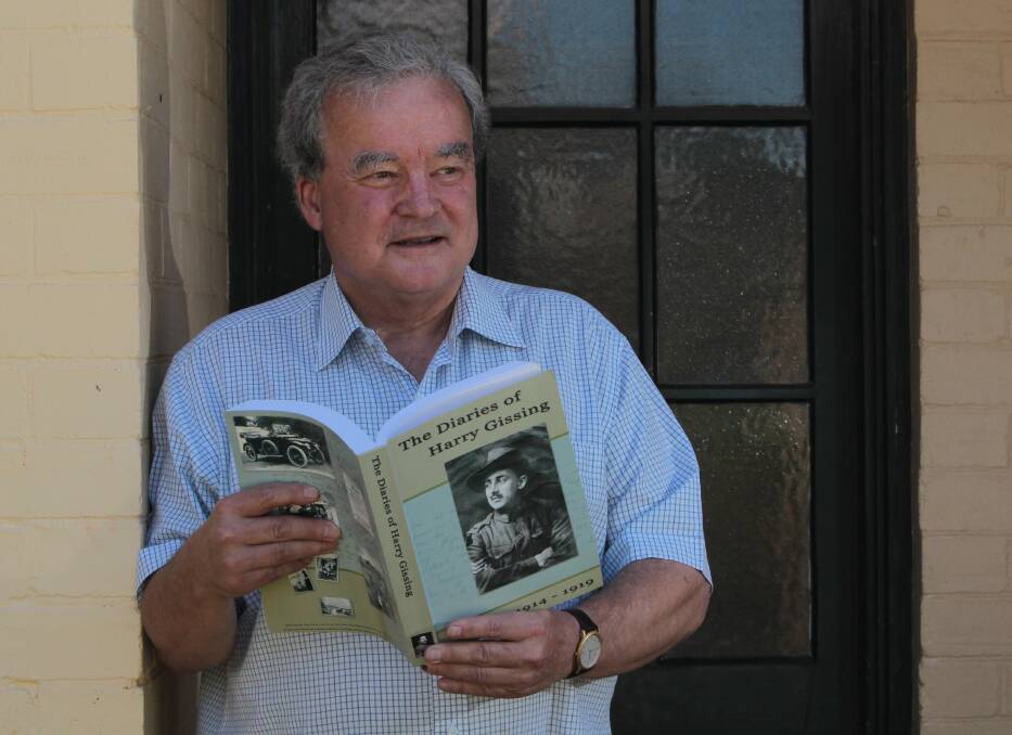 HISTORICAL FAMILY: Peter Gissing with a book featuring the war diaries of his grandfather Harry who established Gissing's Pharmacy when Wagga was battling the Spanish Flu in 1919. Picture: Les Smith