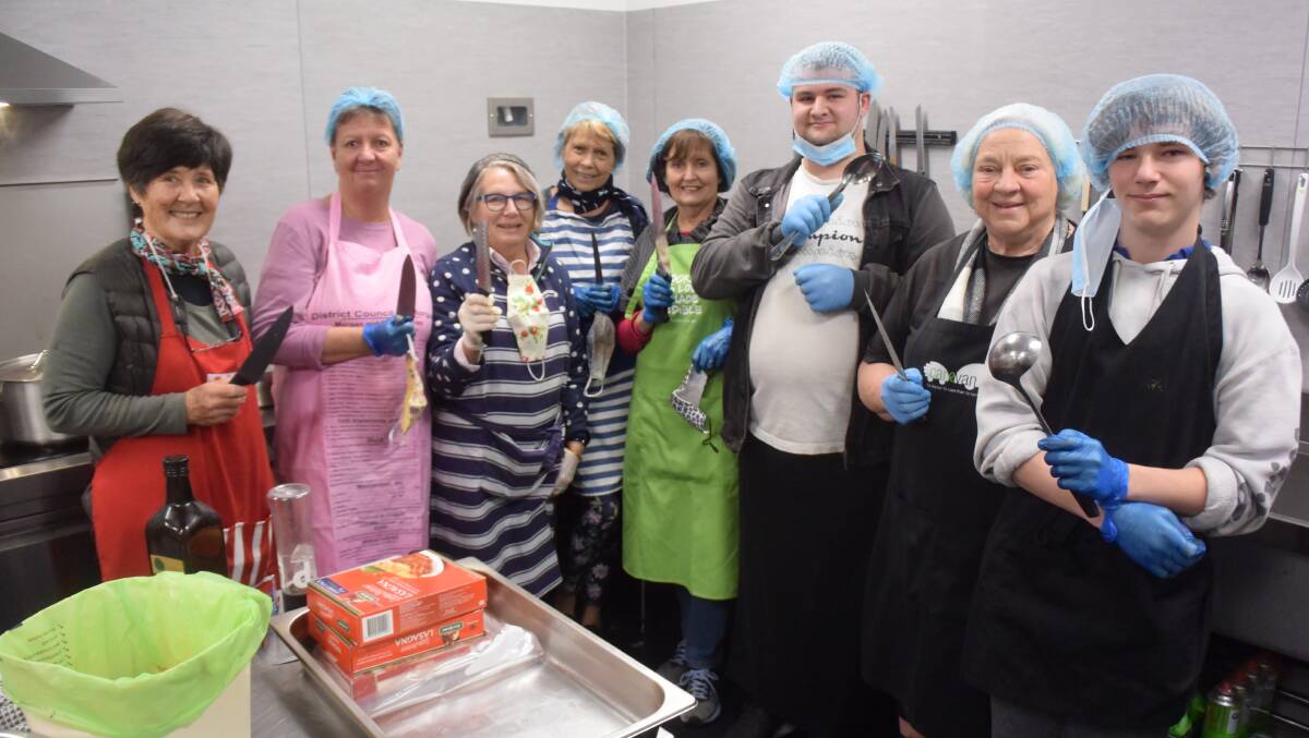 HELPING HANDS: Judith Foley, Bronwen St. Ruth, Prue Mackellar, Jenny Conkey, Carolyn Mulrooney, The Bidgee Schhool workplace student Jack Richardson, Lynne Graham and Caleb Jacobsen from The Bidgee School are part of one of the cooking teams at Carevan. Picture: Sean Cunningham
