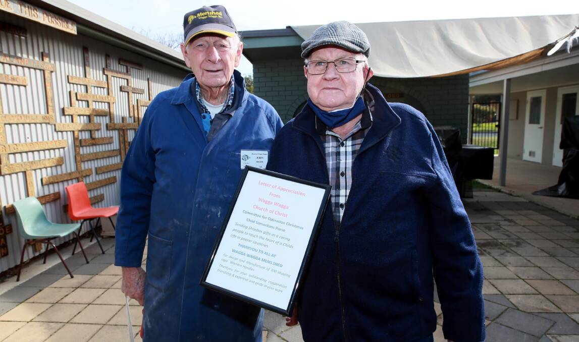 JOINT EFFORT: Lionel Stewart (right) from Samaritan's Purse thanks Men's Shed Wagga member John Mason for his help making skipping rope handles. Picture: Les Smith