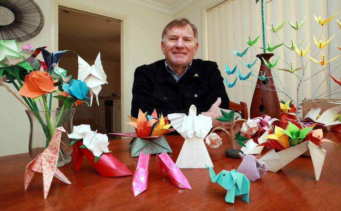 ORIGAMI ARTIST: Bob Reynolds puts a smile on the faces of cafe owners and their customers by leaving origami figures at his favourite coffee drinking haunts. Picture: Les Smith