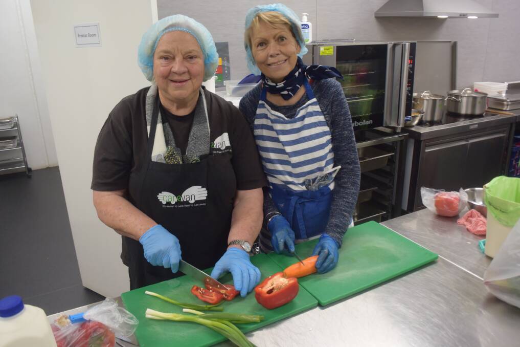 CARING COOKS: Carevan project manager Lynne Graham and volunteer Jenny Conkey prepare some meals to help feed those in need. About 70 trained volunteers help with Carevan progams. Picture: Sean Cunningham