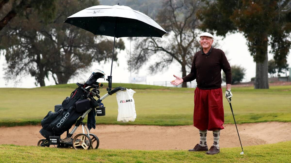 LET IT RAIN: Playing golf since he was a nine-year-old, Rick Tribe, now 83, didn't allow the rain to stop him playing in a competition at Wagga Country Club. Picture: Les Smith