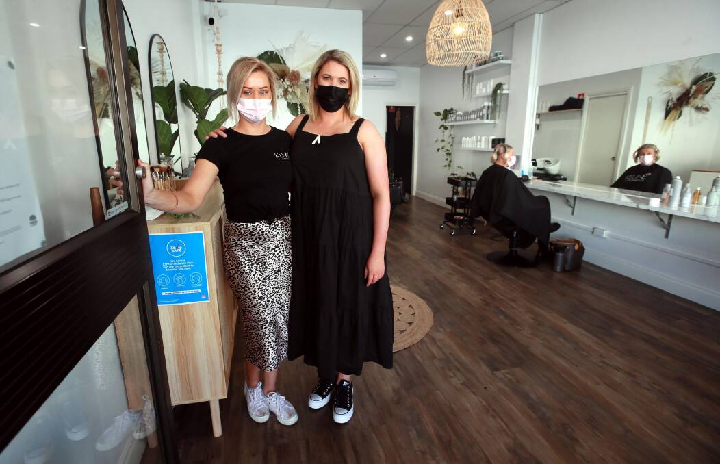 BACK IN ACTION: The Style Bar owner Katie Coote and senior stylist Reihan Osling were excited to reopen on Saturday. Tracey Bell was one of their early customers. Picture: Les Smith