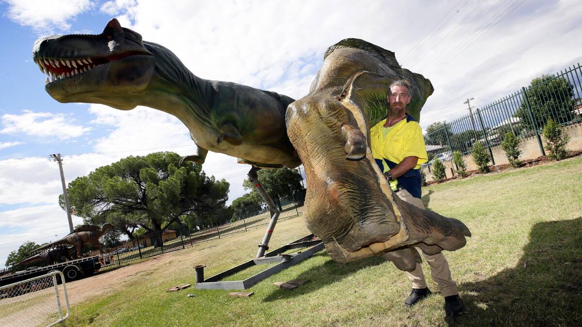 DINO-MITE: Dinosaur Festival Australia operations manager Conon Stevenson with the 13m Tyrannosaurus Rex. Picture: Les Smith.
