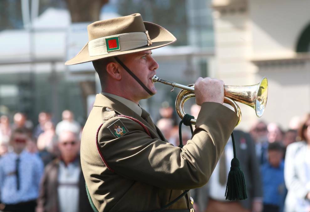 LEST WE FORGET: Bugler Sam Kennedy plays The Last Post beside the cenotaph in the Victory Memorial Gardens during Wagga's 2021 ANZAC Day service. 