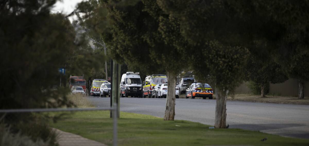 ARREST: Several police units attend the incident at Urana Street, as NSW Ambulance crews wait on standby. Picture: Ash Smith
