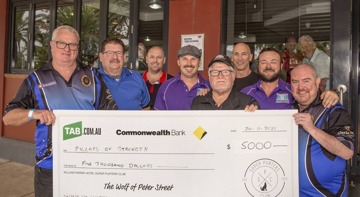 STRONG: The William Farrer Hotel social group presenting charity group Pillars of Strength with a $5000 cheque. Photo: Ash Smith.