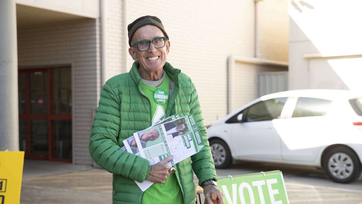 Ray Goodlass handing out how-to-vote cards for The Greens on the first day of pre-polling, 2022. Picture: Madeline Begley