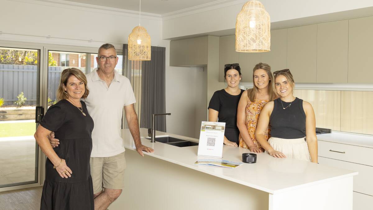 FAMILY FIRST: Cathy and Geoff Reid and their daughters Maddie, Laura and Alyce inside the 12 Kellerman Crescent property which is currently on the market with profits set to lessen the burden of medical bills. Picture: Ash Smith.