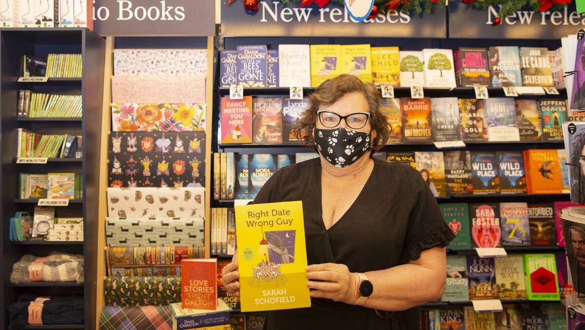 NEW RELEASE: Jenny Leggett from Collins Booksellers Wagga is happy to have helped Sarah Schofield accomplish her dream. Picture: Ash Smith.