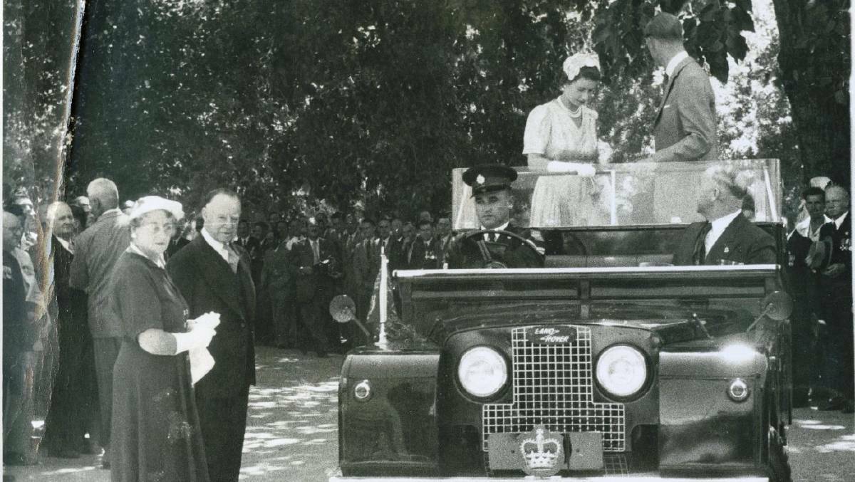 Her Majesty the Queen, the Duke and Edinburgh aboard a Land Rover, travelling through the ranks of ex-servicemen and women.