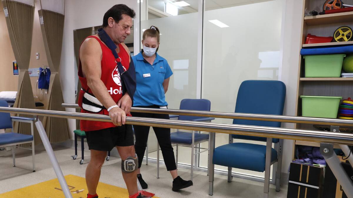 ON THE MEND: Robbie Honeyman has benefited from a recent acquisition of a rehab device known as the Bioness leg stimulator, from the donation of funds from the Wagga Base Hospital Auxiliary. With rehab physio Sam Doolan. Picture: Les Smith