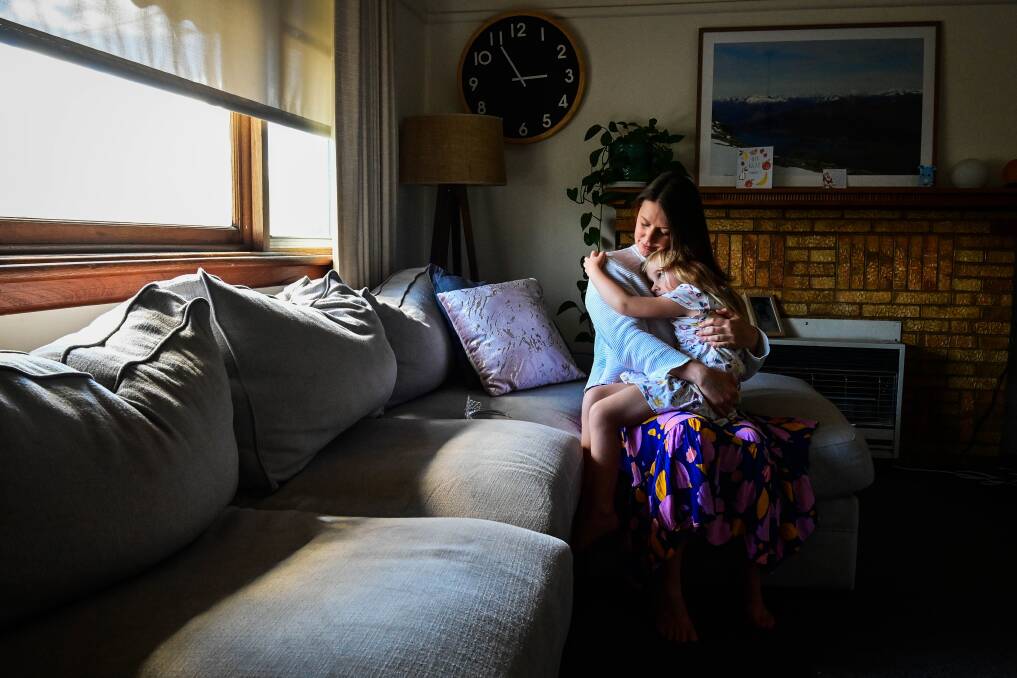 TERRIFYING: Aimee Howlett holds her daughter Eadie Glatz in their Bendigo home. Picture: BRENDAN MCCARTHY